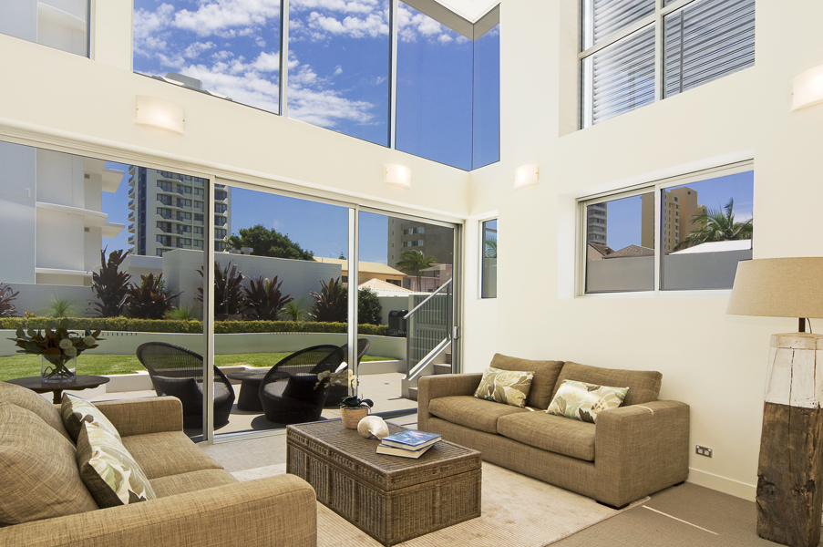 Double-height living room with full-height glass